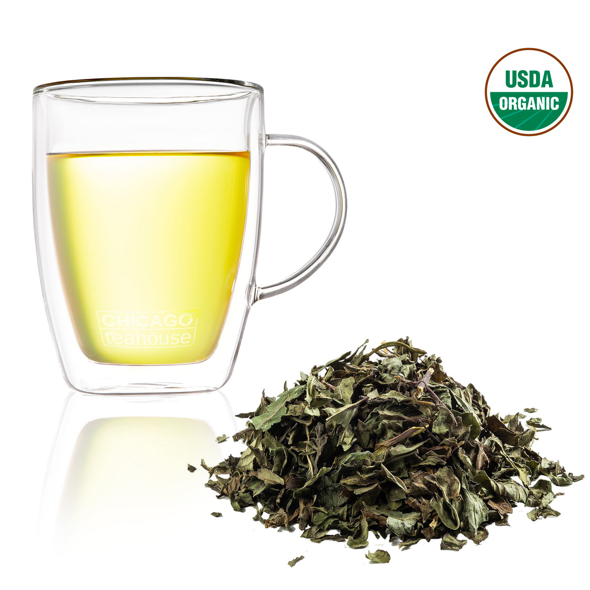 A mug of peppermint tea garnished with dried peppermint leaves, featuring USDA Organic badge.
